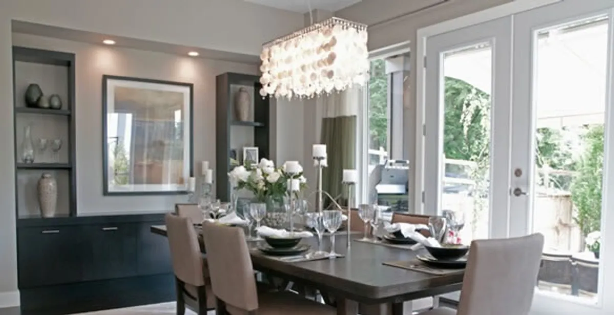 Elegant dining room chandelier installation above table in Louisville, KY