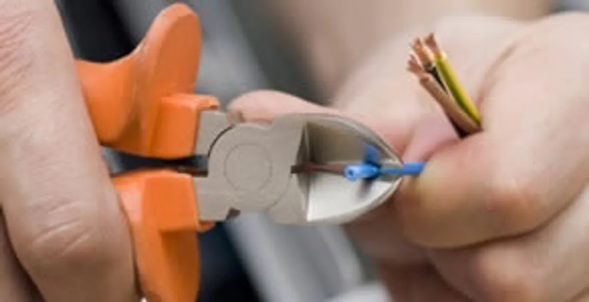 professional electrical services showing precise wire cutting by licensed electricians in Louisville, KY